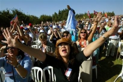 Christian pilgrims from various nations on a pilgrimage to Israel participate in a group prayer, during an event of the International Christian Embassy in Jerusalem, Sunday, Oct. 3, 2004. Led by American evangelist Pat Robertson, thousands of Christian pi