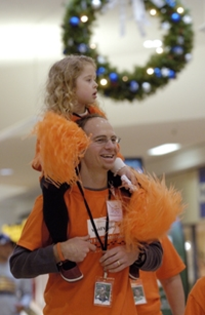 Hallie Systma, 4, catches a lift on her father's shoulders after walking enthusiastically for most of the distance for ''6,000 steps for 6,000 orphans'' in Seattle, WA. According to sources, Every day, more than 6,000 children join the 15 million childre