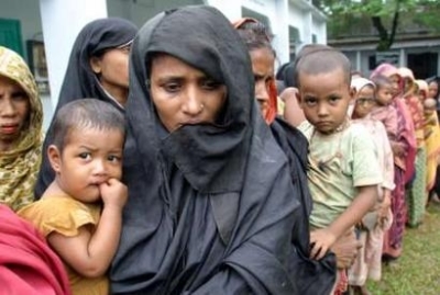 Bangladeshi flood victims line up for relief supplies in Sunamganj on July 13, 2004. In some areas of flood-hit Bangladesh, floods submerged crops and cut rail and road links, pushing up food prices and forcing thousands of people to cram into government