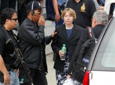 Former American hostage Gracia Burnham, third from left, leaves a special court at a Philippine National Police Camp in Bicutan, south of Manila, Philippines, shortly after testifying against her captured Muslim Abu Sayyaf kidnappers on Thursday, July 29,