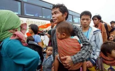 Montagnard hill tribe people board a bus after arriving at Phnom Penh International airport, July 28, 2004. A group of 38 from a steady stream of Montagnards, a minority hill tribesmen who practice Protestantism, have been trickling over the border follow