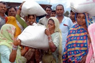 Indian flood victims carry wheat near a relief camp in Khagaria 250 km (156 miles) from Patna, the eastern Indian state of Bihar. The worst floods in 15 years have hit South Asia over the past few weeks, making millions of people homeless and killing more