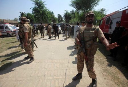 An Army soldier stops member of the media (unseen) as he guards the area with others, after suicide bombers attacked a Christian neighbourhood in Khyber Agency near Peshawar, Pakistan, September 2, 2016.