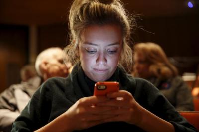 Iowa State University student Carolyn Green, 20, signs up via text message to support U.S. Democratic presidential candidate Hillary Clinton during a campaign rally at Iowa State University in Ames, Iowa, January 12, 2016.