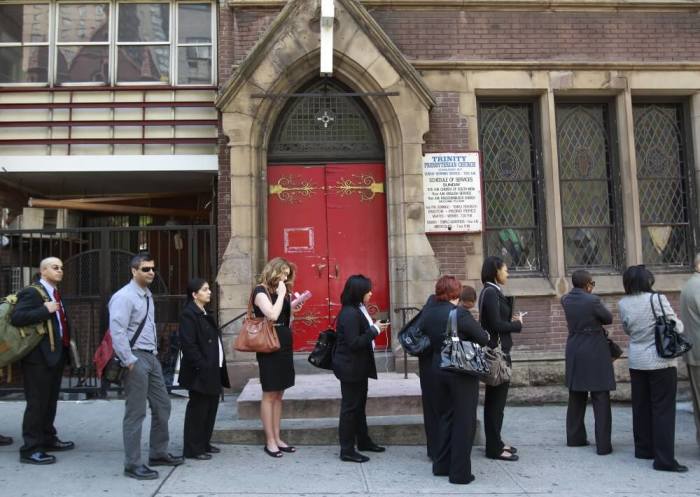 People wait in line to enter a job fair in New York April 18, 2012.