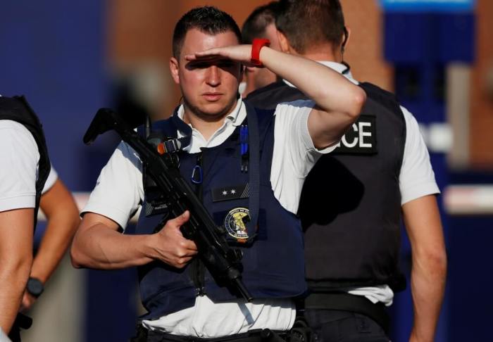 Belgian police officers stand guard outside the main police station after a machete-wielding man injured two female police officers before being shot in Charleroi, Belgium, August 6, 2016.