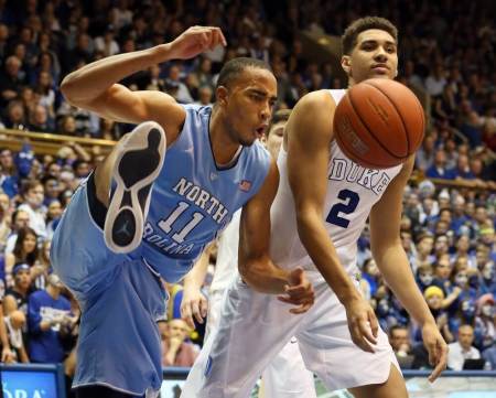 Mar 5, 2016; Durham, NC, USA; North Carolina Tar Heels forward Brice Johnson (11) reacts after dunking over Duke Blue Devils forward Chase Jeter (2) in the first half of their game at Cameron Indoor Stadium.