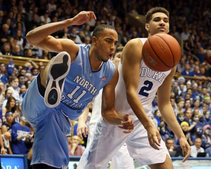 Mar 5, 2016; Durham, NC, USA; North Carolina Tar Heels forward Brice Johnson (11) reacts after dunking over Duke Blue Devils forward Chase Jeter (2) in the first half of their game at Cameron Indoor Stadium.