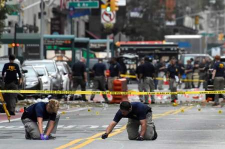 Federal Bureau of Investigation (FBI) officials mark the ground near the site of an explosion in the Chelsea neighborhood of Manhattan, New York, U.S. September 18, 2016.