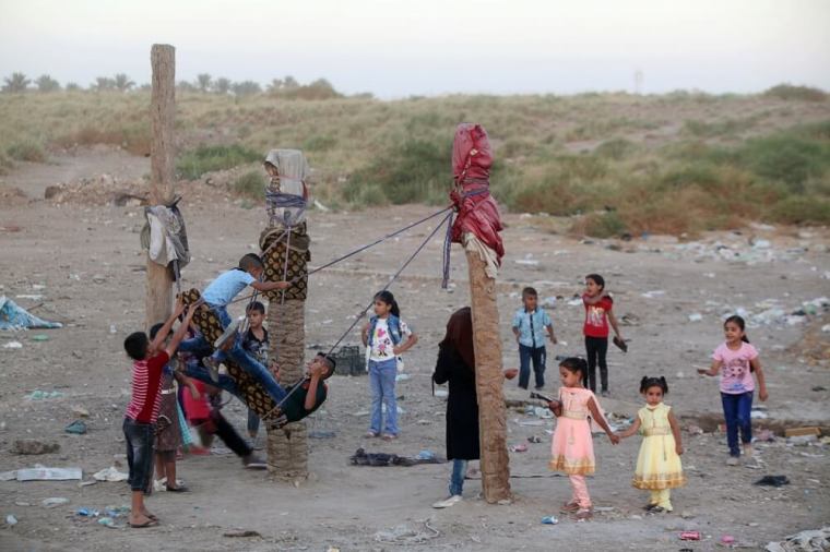 Iraqi children enjoy a swing ride as they celebrate the Muslim festival of Eid al-Adha in the city of Hilla, south of Baghdad, Iraq, September 13, 2016.