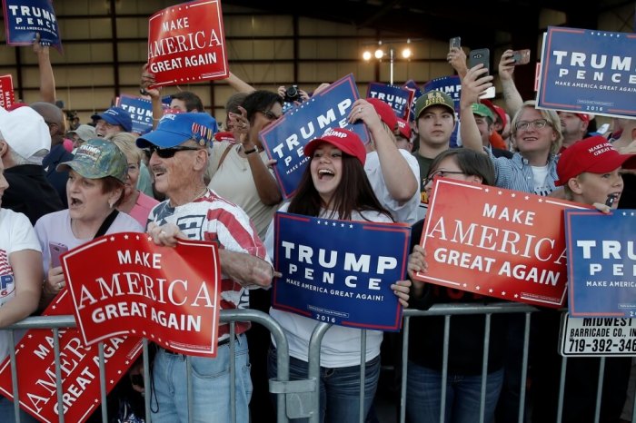 Supporters cheer Republican presidential nominee Donald Trump as his plane arrives at a campaign rally in Colorado Springs, Colorado, September 17, 2016.