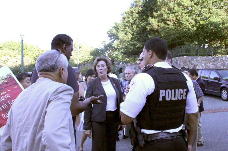 Human rights activist Suzanne Scholte tells police why people are protesting outside the Chinese Embassy in Washington, D.C. on Sept. 23, 2013.