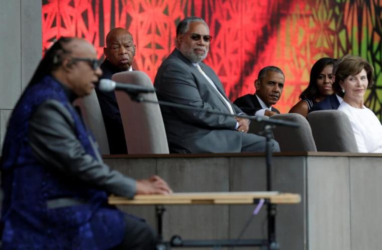 U.S. President Barack Obama with First Lady Michelle Obama and former First Lady Laura Bush listen as Stevie Wonder performs 'Visions' during the dedication and grand opening of the Smithsonian Institution's National Museum of African American History and Culture in Washington, U.S., September 24, 2016.