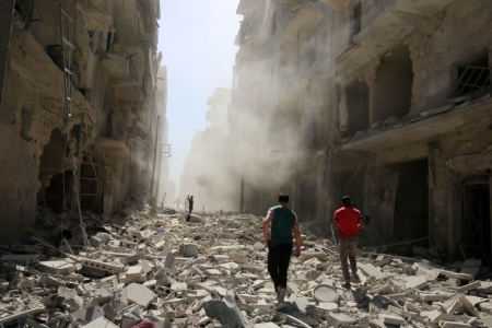 Men inspect the damage after an airstrike on the rebel held al-Qaterji neighbourhood of Aleppo, Syria, September 25, 2016.