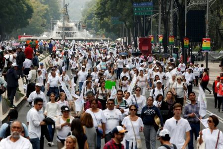 People dressed in white arrive to participate in a march against the legalization of gay marriage and to defend their interpretation of traditional family values near the Angel of Independence monument in Mexico City, Mexico, September 24, 2016.