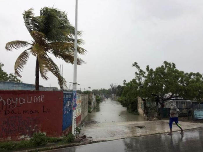 A man walks past a flooded street while Hurricane Matthew passes, in Cite-Soleil in Port-au-Prince, Haiti, October 4, 2016.