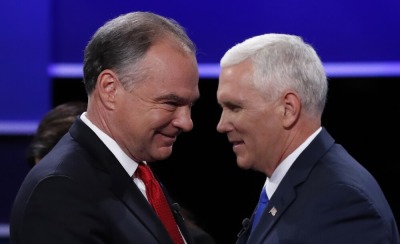 Democratic U.S. vice presidential nominee Senator Tim Kaine (L) and Republican U.S. vice presidential nominee Governor Mike Pence pass each other on stage at the conclusion of their vice presidential debate at Longwood University in Farmville, Virginia, U.S., October 4, 2016.