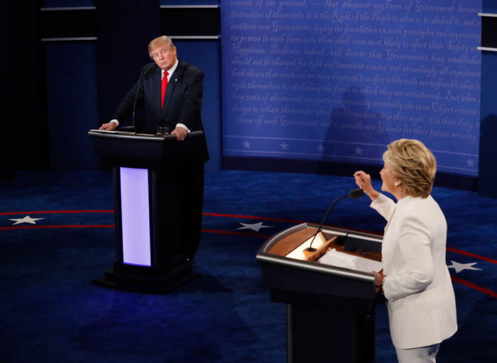 Republican U.S. presidential nominee Donald Trump listens as Democratic U.S. presidential nominee Hillary Clinton speaks during their third and final 2016 presidential campaign debate at UNLV in Las Vegas, Nevada, U.S., October 19, 2016.