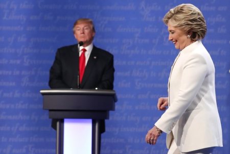 Democratic U.S. presidential nominee Hillary Clinton walks off the debate stage as Republican U.S. presidential nominee Donald Trump remains at his podium after the conclusion of their third and final 2016 presidential campaign debate at UNLV in Las Vegas, Nevada, U.S., October 19, 2016.