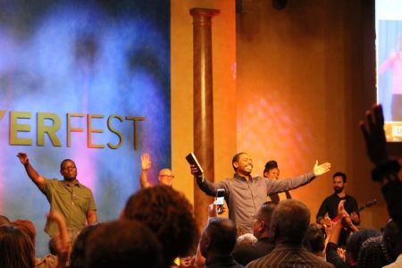 David Ireland (with Bible), founding pastor of Christ Church in northern New Jersey ministers at an annual all day prayer event called PrayerFest on Friday, October 21, 2016