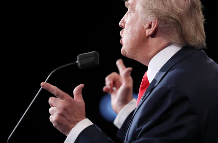 Republican U.S. presidential nominee Donald Trump speaks as Democratic U.S. presidential nominee Hillary Clinton listens during their third and final 2016 presidential campaign debate at UNLV in Las Vegas, Nevada, U.S., October 19, 2016.