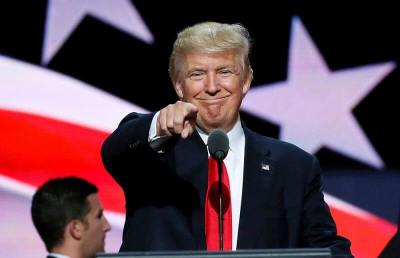 Republican presidential nominee Donald Trump points at the gathered media during his walk through at the Republican National Convention in Cleveland, Ohio, July 21, 2016.