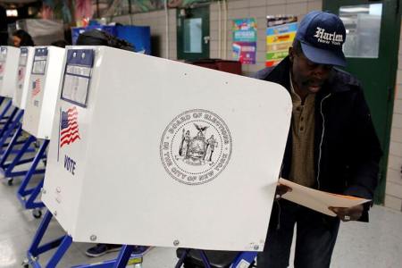 A man fills out a ballot for the U.S presidential election at the James Weldon Johnson school in the East Harlem neighbourhood of Manhattan, New York City, November 8, 2016.