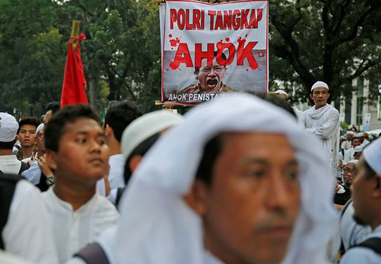 Members of hardline Muslim groups attend a protest against Jakarta's incumbent governor Basuki Tjahaja Purnama. The poster reads 'Ahok should be jailed.'