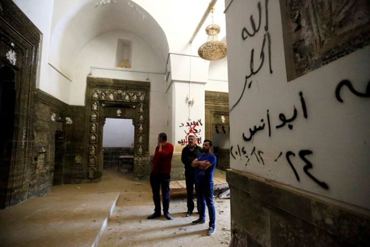 People inspect the Mar Behnam monastery after the town was recaptured from the Islamic State, in Ali Rash, southeast of Mosul, Iraq, November 21, 2016.