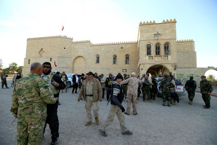 Fighters from the 'Kataeb Babylon,' a group of Christian fighters who fight alongside the Hashd Shabi, Shi'ite fighters, gather at the Mar Behnam monastery after the town was recaptured from the Islamic State, in Ali Rash, southeast of Mosul, Iraq, November 21, 2016.