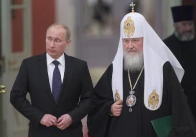 Russia's President Vladimir Putin (L) and Patriarch of Moscow and All Russia Kirill arrive for the meeting with Russian Orthodox Church bishops in Moscow on February 1, 2013.