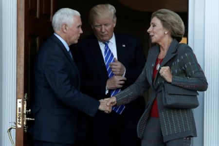 U.S. President-elect Donald Trump (C) and Vice President-elect Mike Pence (L) emerge with Betsy DeVos after their meeting at the main clubhouse at Trump National Golf Club in Bedminster, New Jersey, U.S., November 19, 2016.