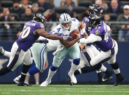 Dallas Cowboys quarterback Dak Prescott (4) is sacked in the first quarter by Baltimore Ravens linebacker Zachary Orr (50) and defensive tackle Timmy Jernigan (99) at AT&T Stadium, Arlington, Texas, November 20, 2016.