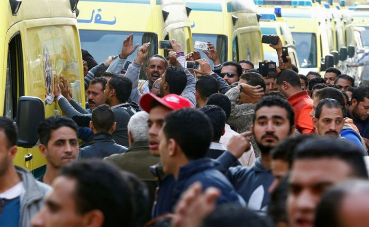 Egyptian Christians shout slogans as ambulances transport the bodies of victims killed in the bombing of Cairo's main Coptic cathedral after the funeral, in Cairo, Egypt, December 12, 2016.