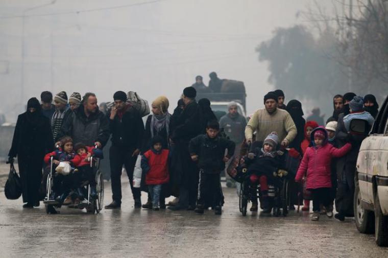 People walk as they flee deeper into the remaining rebel-held areas of Aleppo, Syria, December 13, 2016.