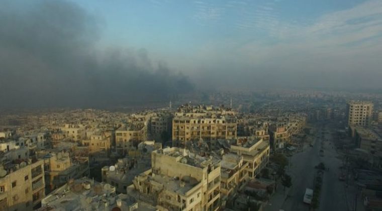 A still image from video taken December 12, 2016 of a general view of smoke rising over bomb damaged eastern Aleppo, Syria. Video released December 12, 2016.