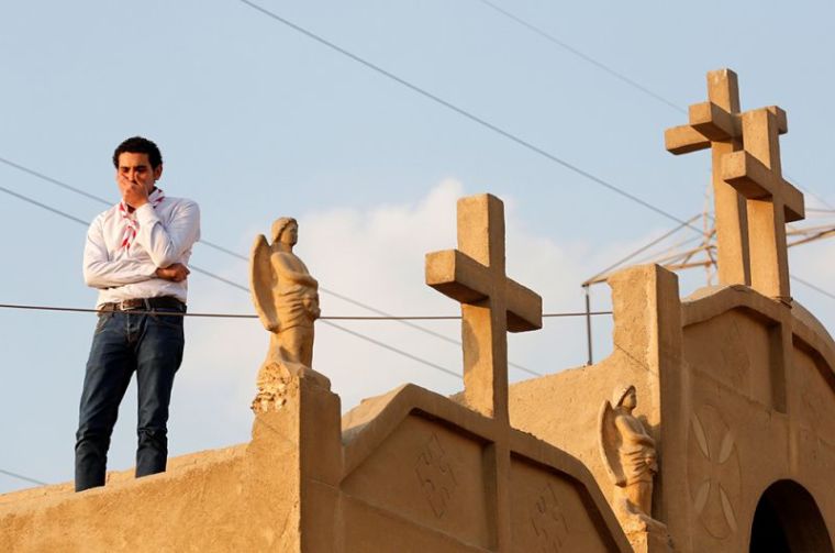 A man cries during the funeral of victims killed in the bombing of Cairo's Coptic cathedral, at the Mokattam Cemetery in Cairo, Egypt, December 12, 2016.