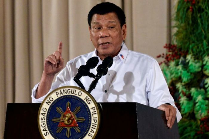 Philippine President Rodrigo Duterte gestures as he delivers a speech during an awarding ceremony for outstanding Filipinos and organizations overseas, at the Malacanang Palace in Manila, Philippines December 19, 2016.