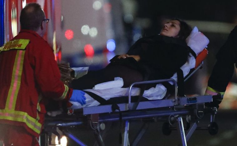 A survivor of an accident with a Polish truck is rescued on a stretcher near a Christmas market on Breitscheidplatz square near the fashionable Kurfuerstendamm avenue in the west of Berlin, Germany, December 19, 2016.