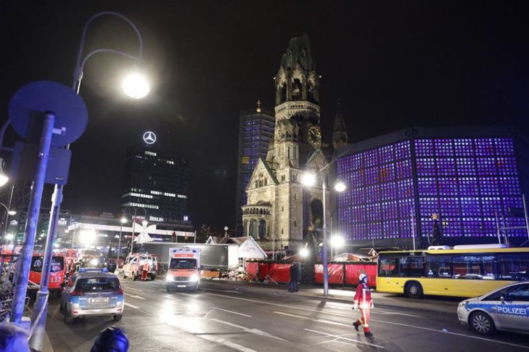 An official walks near a Christmas market in Berlin, Germany, December 19, 2016 after a truck ploughed into the crowded Christmas market in the German capital.