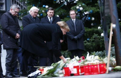 German Chancellor Angela Merkel lays flowers at the Christmas market in Berlin.