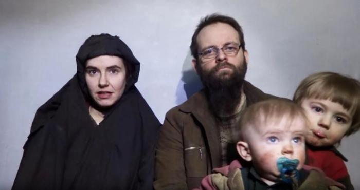 A still image from a video posted by the Taliban on social media on December 19, 2016 shows American Caitlan Coleman (L) speaking next to her Canadian husband Joshua Boyle and their two sons.