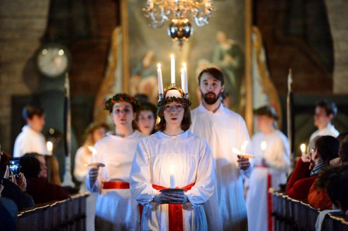 The 'Kongl. Teknologkoren' choir performs in Seglora church at the open-air museum Skansen on Saint Lucy's Day in Stockholm, Sweden, December 13, 2016.