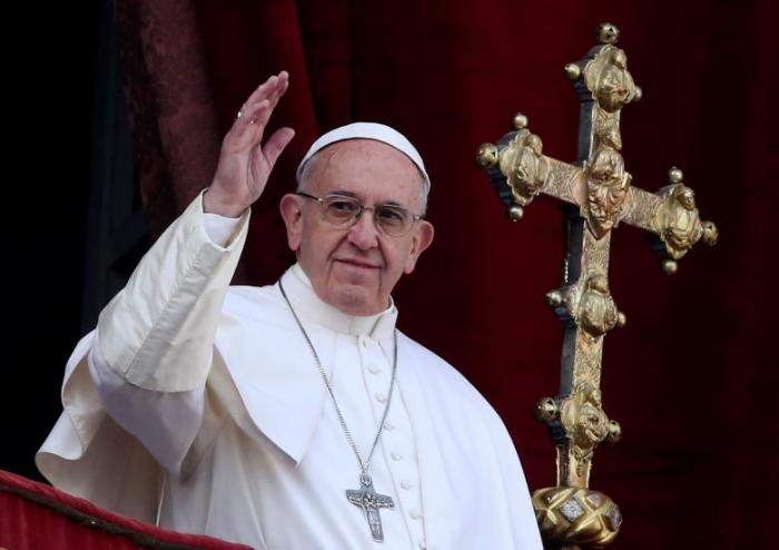 Pope Francis waves after delivering his ''Urbi et Orbi'' (to the city and the world) message from the balcony overlooking St. Peter's Square at the Vatican, Rome, Italy, December 25, 2016.