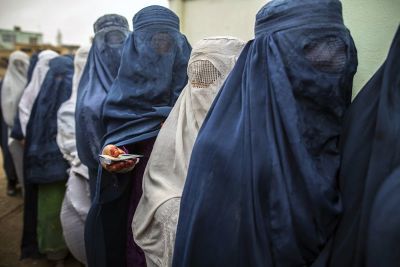 Afghan women stand in line while waiting for their turn to vote at a polling station in Mazar-i-sharif April 5, 2014. Voting was peaceful during the first few hours of Afghanistan's presidential election on Saturday, with only isolated attacks on polling stations as the country embarked on the first democratic transfer of power since the fall of a Taliban regime in 2001.