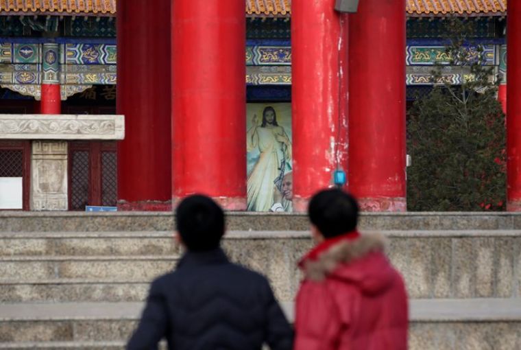 People visit a square to pray, on the top of a hill, near a Catholic church on the outskirts of Taiyuan, North China's Shanxi province, December 24, 2016.