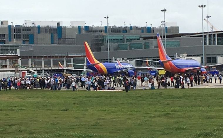 Travelers are evacuated out of the terminal and onto the tarmac after airport shooting at Fort Lauderdale-Hollywood International Airport in Florida, January 6, 2017.