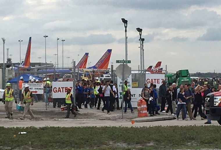 Travelers and airport workers are evacuated out of the terminal after airport shooting at Fort Lauderdale-Hollywood International Airport in Florida, January 6, 2017.