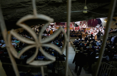 Coptic priests pray during Egypt's Coptic Christmas eve mass in a church of the Samaan el-Kharaz Monastery in the Mokattam Mountain area of Cairo, Egypt January 6, 2017.