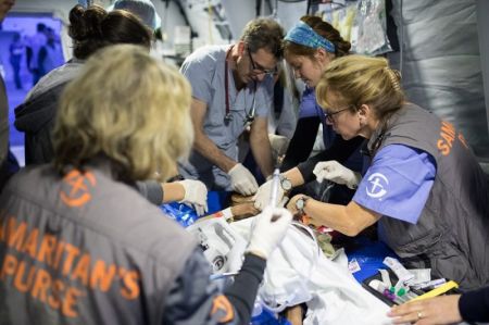 Doctors and medical professionals at Samaritan's Purse's field hospital outside of Mosul, Iraq work to save the life of a patient wounded in the fight against the Islamic State in January 2017.